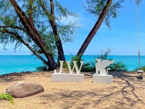 Private beach, white sand, sun-loungers, windsurfing