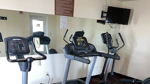 A fitness center with treadmills, an elliptical, and a stationary bike.