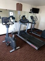 A fitness center with treadmills, an elliptical, and a stationary bike.