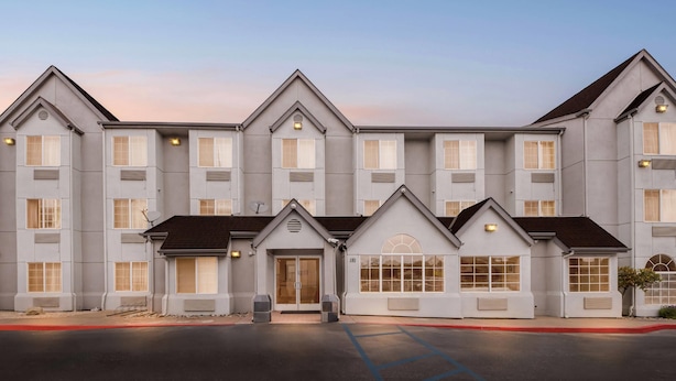 A multi-story hotel with a symmetrical facade, large windows, and a central entrance. - Comfort Inn & Suites Salinas City Center Area (Salinas)
