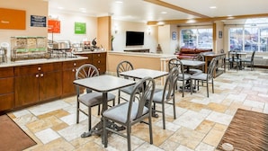 A hotel lobby with a coffee station, seating area, and a television. - Comfort Inn & Suites Salinas City Center Area (Salinas)