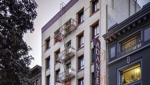 A hotel with a fire escape, a restaurant, and a pizza place on the ground floor. - Adante Hotel (San Francisco)