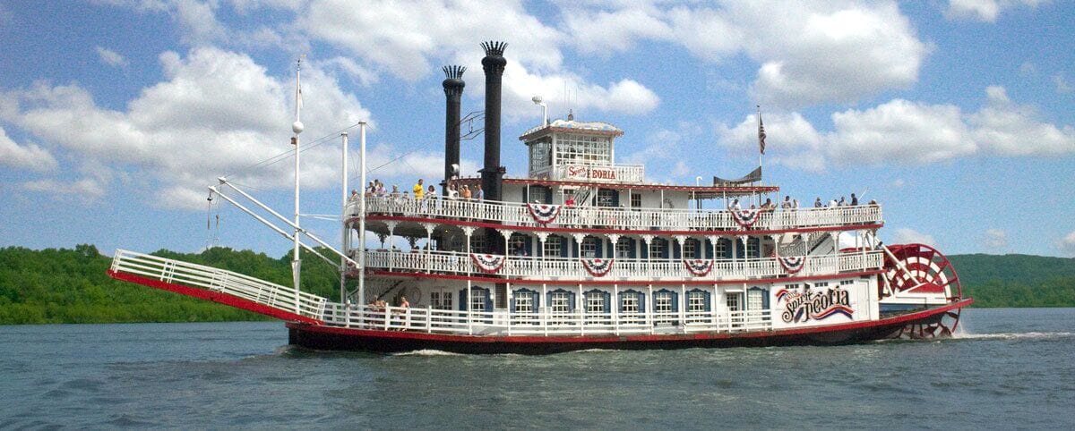 A large riverboat with multiple decks and a prominent wheelhouse.