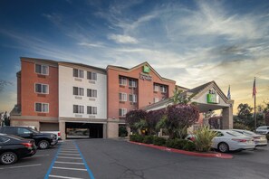 A Holiday Inn Express building with a parking lot in front.