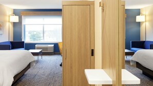 A hotel room with two beds, a small table, a chair, and a window with a view of trees. - Holiday Inn Express Castro Valley - I-580 by IHG (Castro Valley)