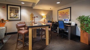 A hotel lobby with a reception desk, seating area, and a large framed artwork on the wall. - Holiday Inn Express Castro Valley - I-580 by IHG (Castro Valley)