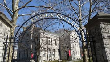 A stone building with a large arched entrance labeled "Johnson College".