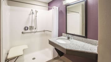 A bathroom with a shower, toilet, and sink.