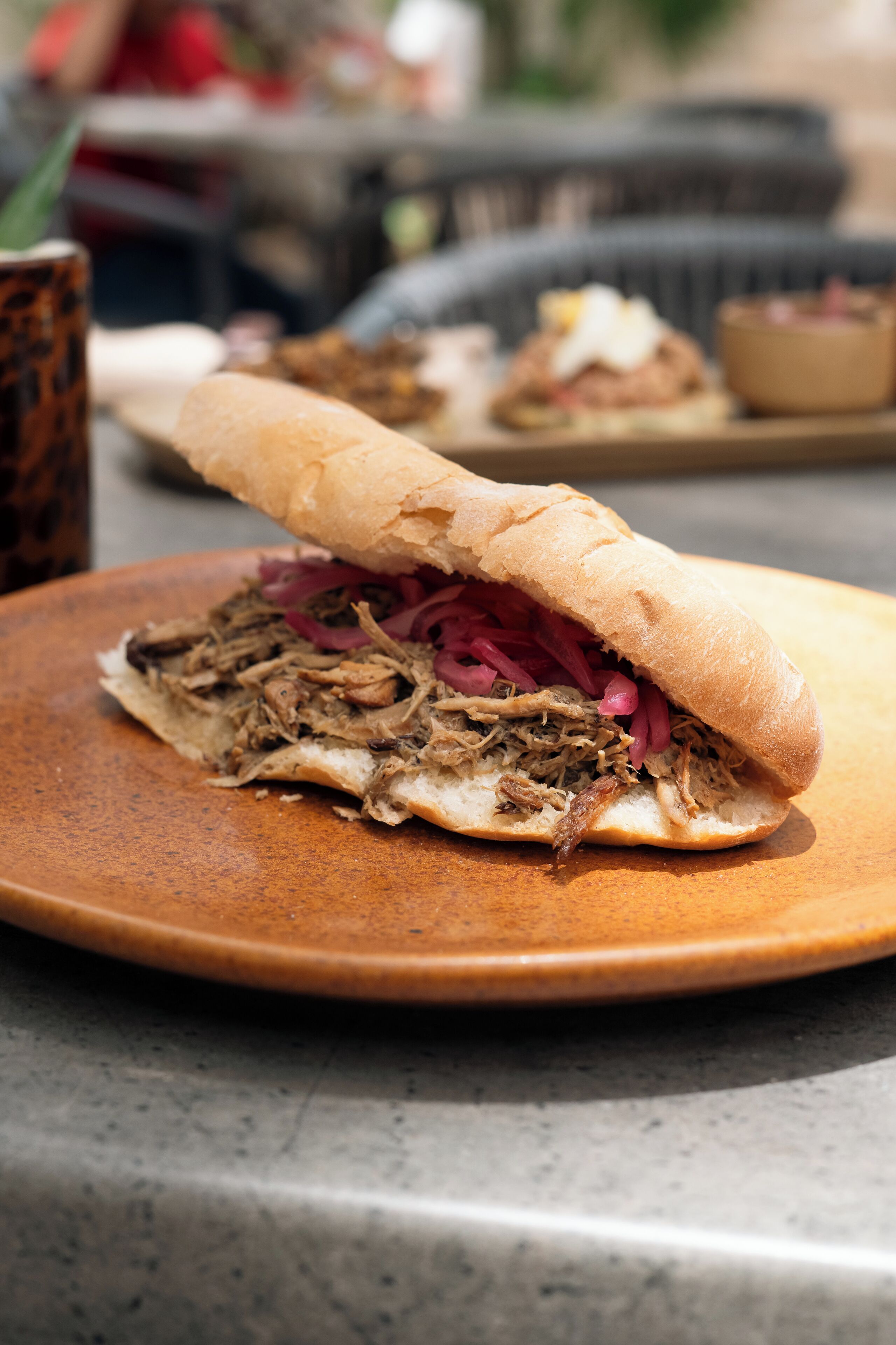 A sandwich on a plate with a blurred background.