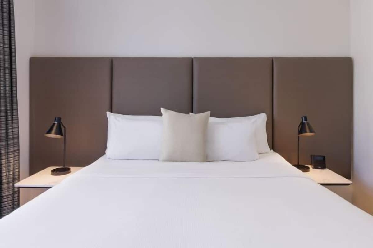 Ropa de cama hipoalergénica y caja de seguridad en la habitación