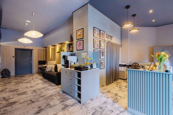 Experience a clean and contemporary lobby with a reception desk, seating area, and artwork.