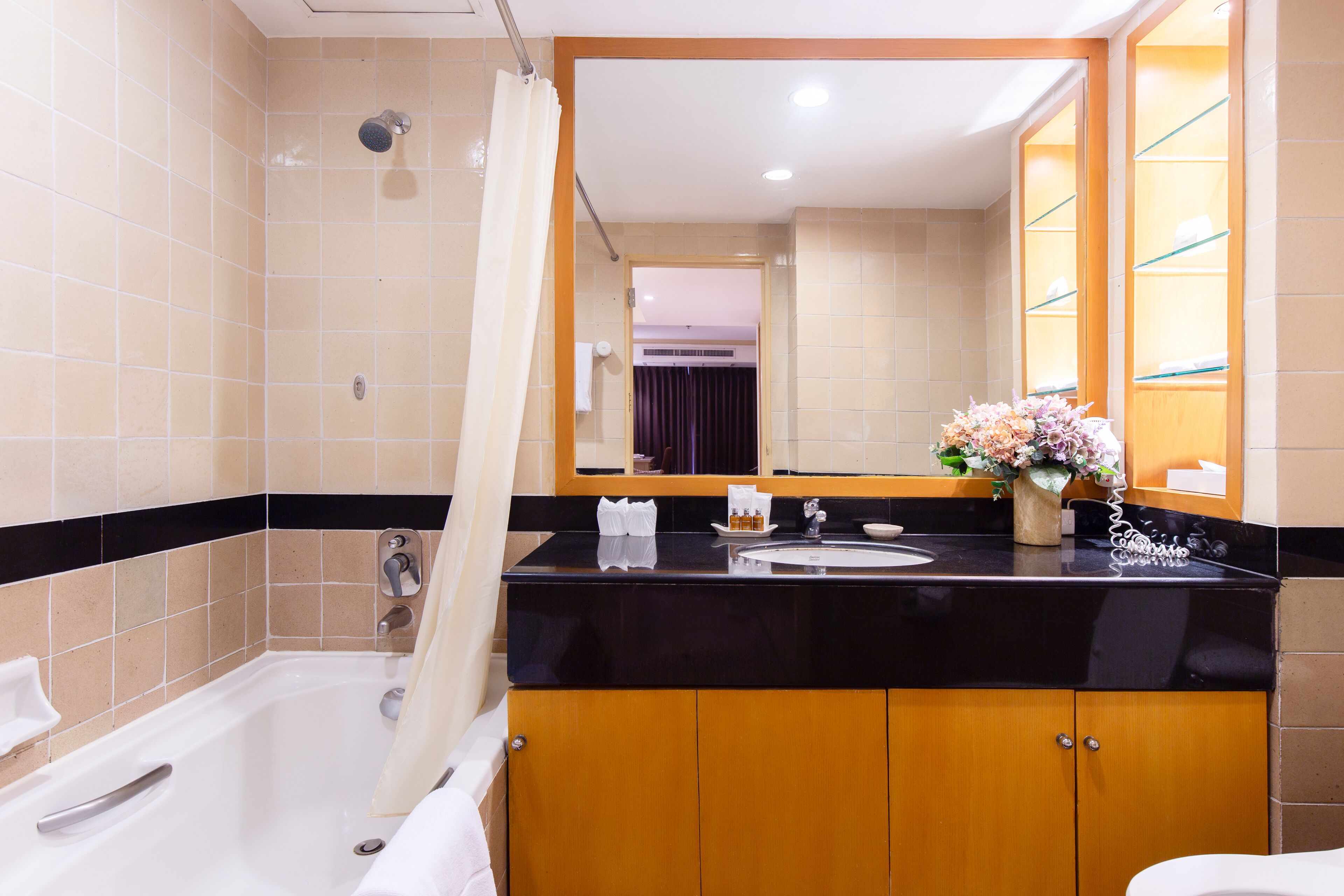 Un bagno con una vasca, un lavandino e uno specchio.