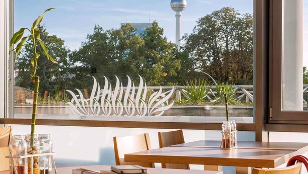 Een eetgedeelte met een tafel, stoelen en uitzicht op de Berliner Fernsehturm.