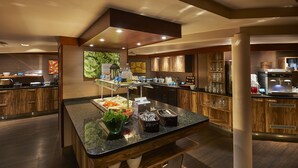A modern kitchen with a central island, wooden cabinets, and a coffee machine. - Scandic Lahti City (Lahti)