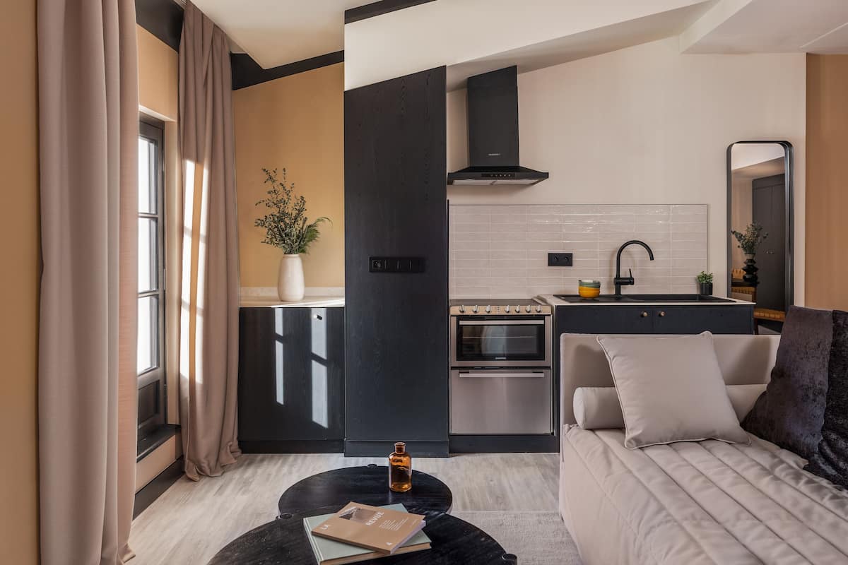 A modern kitchen with a built-in oven, a sink, and a stove.