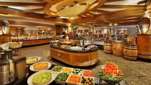 A buffet area with various food stations and a central serving counter. - NH Johannesburg Sandton Hotel (Johannesburg)