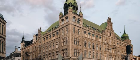 A historic building with multiple towers and arched windows, likely a hotel.
