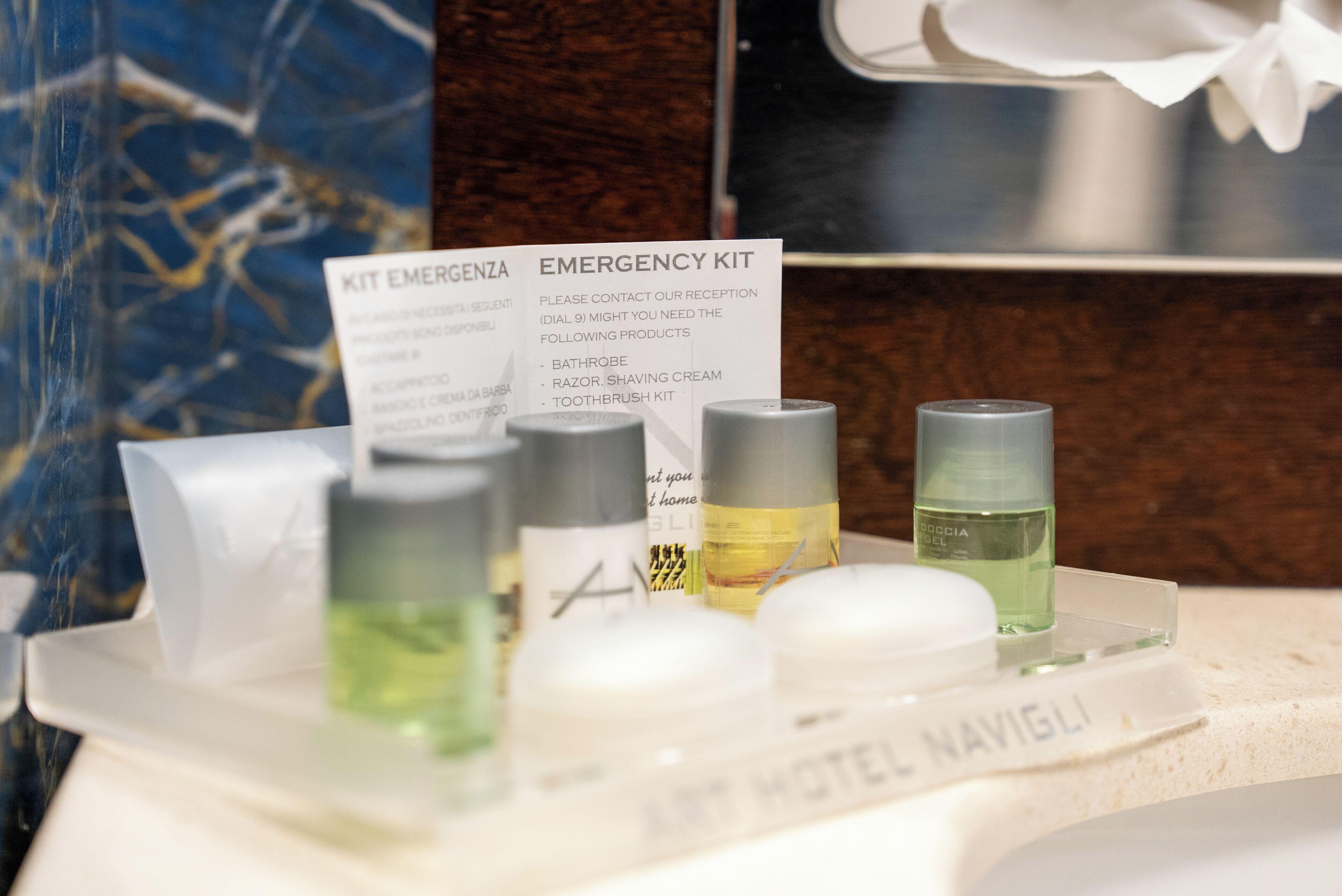 A hotel emergency kit with toiletries including a razor, shaving cream, and toothbrushes.