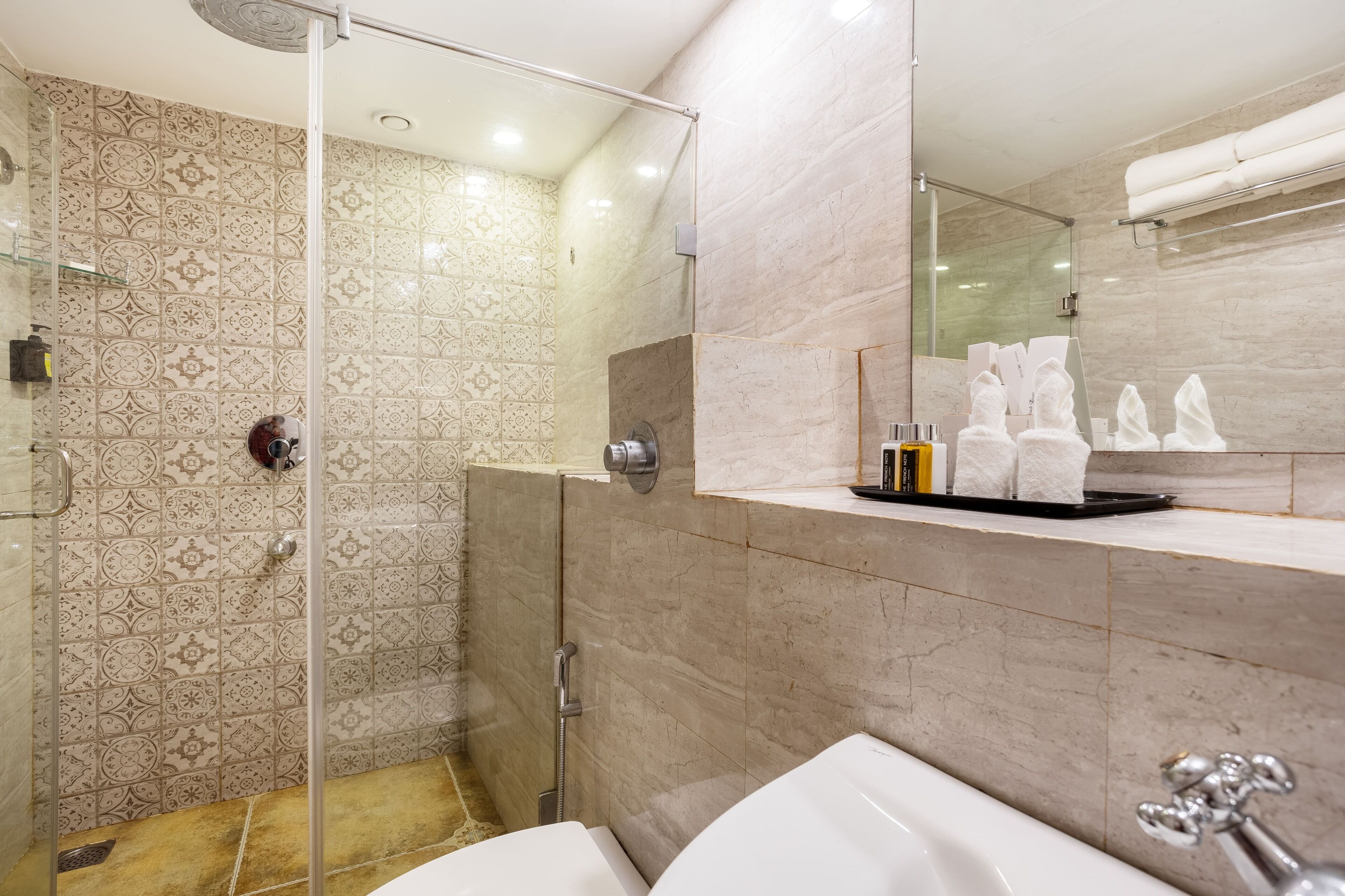 A modern bathroom with a shower, a bathtub, and a vanity with a towel rack.