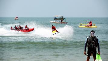 A group of people kayaking on a calm sea.