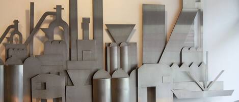 A modern abstract sculpture with geometric shapes and metallic surfaces.