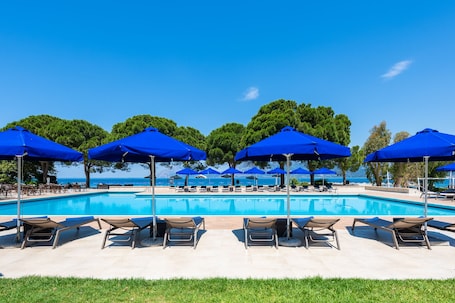 Seasonal outdoor pool, open 11:00 AM to 7:00 PM, pool umbrellas