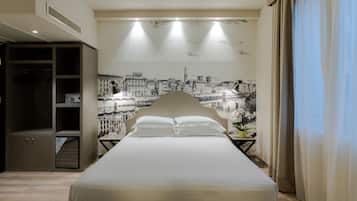 A hotel room with a large bed, a wardrobe, a nightstand with a lamp, and a wall mural of a cityscape.
