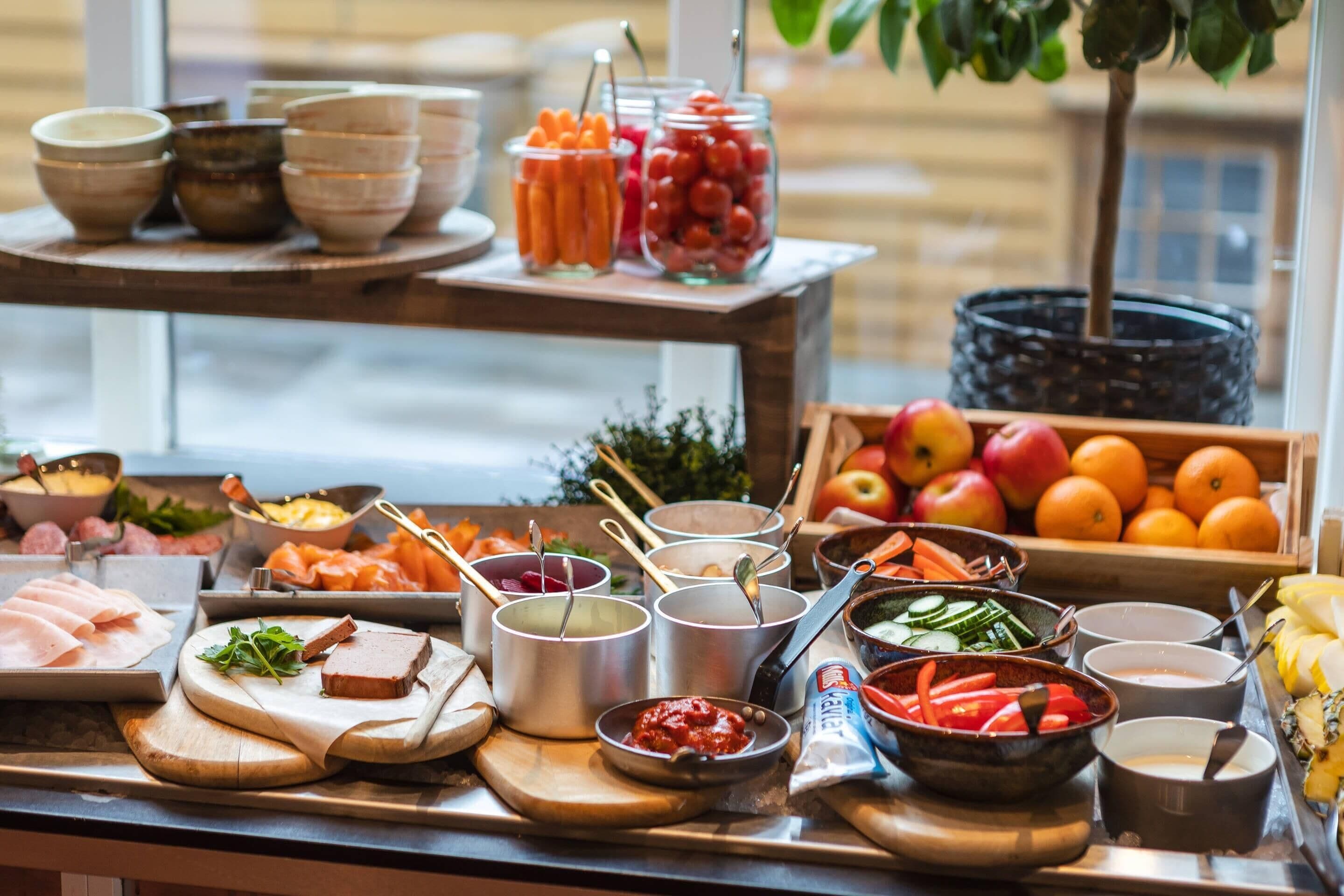 A buffet with various food items and condiments.