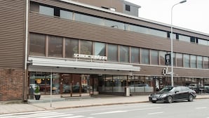 A modern building with a storefront named "Scandinavian Seinäjoki" and a restaurant named "Olive" on the ground floor.