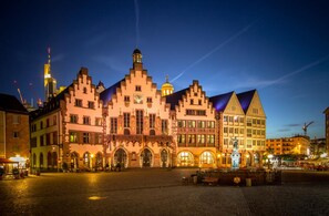 Explore the historic architecture of this iconic landmark, featuring a striking central tower and arched windows.