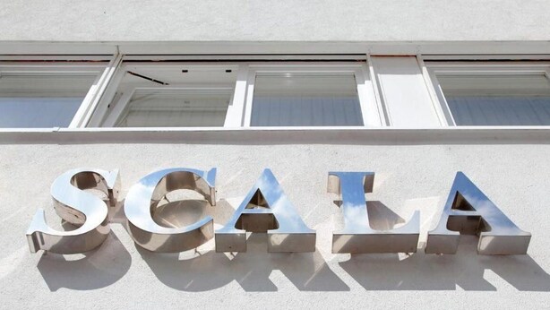 A building with the word "SCALE" in large, metallic letters on its facade.
