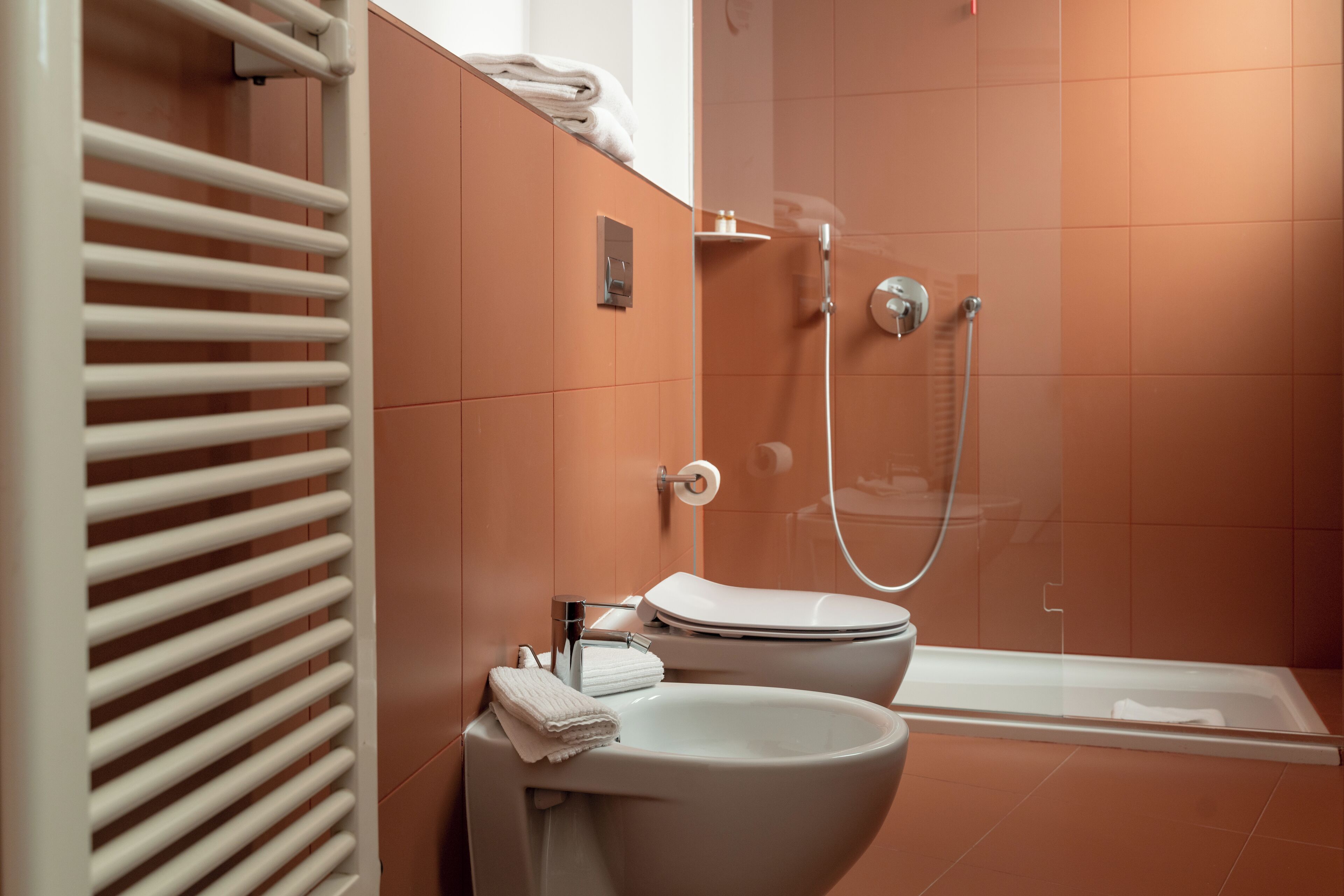 A modern bathroom with a toilet, sink, and shower.