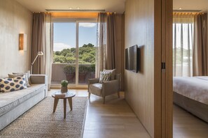 A modern hotel room with a sofa, armchair, small table, and a bed. - The Margi (Vari-Voula-Vouliagmeni)