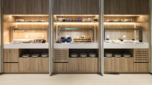 A modern kitchen with wooden cabinets, white countertops, and built-in shelves for dishes and utensils. - VP SOGNIO Madroño (Madrid)