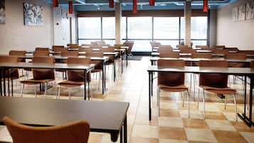 A conference room with tables and chairs arranged for meetings.