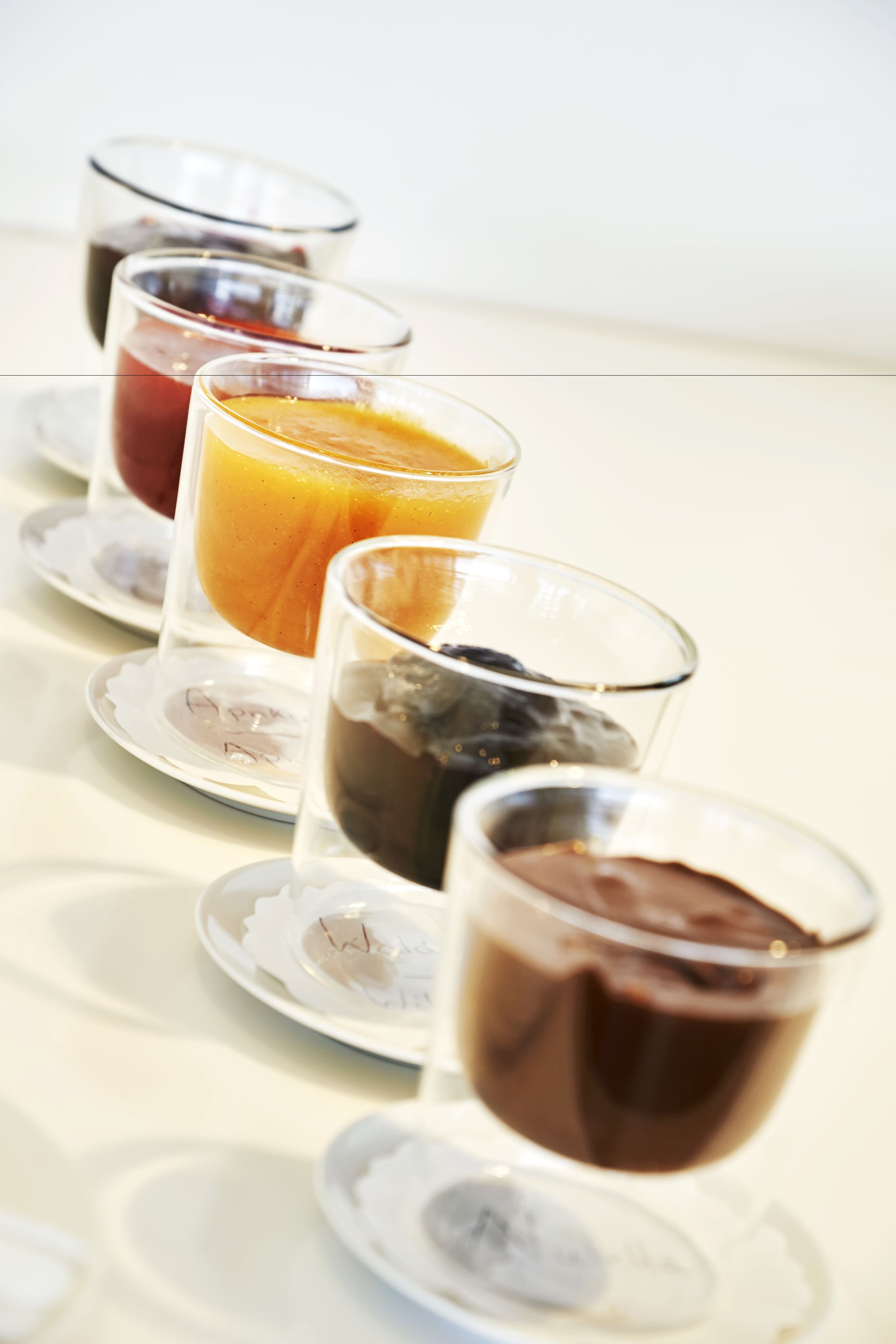 A breakfast setting with various drinks on plates.