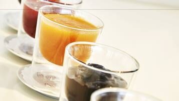A breakfast setting with various drinks on plates.