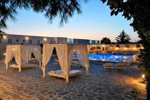 Outdoor pool, open 11:00 AM to 7:00 PM, pool umbrellas, pool loungers
