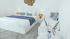 A modern bedroom with a large bed, bedside tables, and a decorative wall piece.