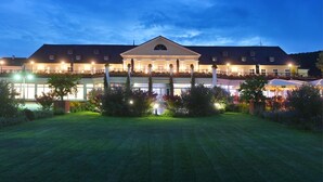 A large, well-lit building with a symmetrical facade, multiple windows, and a central entrance. - Kurpark-Hotel Bad Dürkheim (Bad Durkheim)