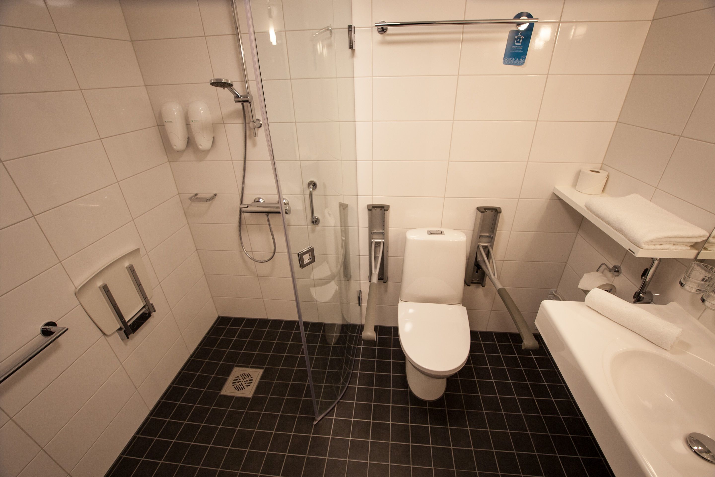 A bathroom with a shower, toilet, and bathtub.