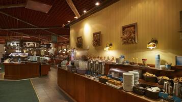 Een buffetruimte met diverse food stations, zowel warme als koude gerechten, en een koffiehoek.