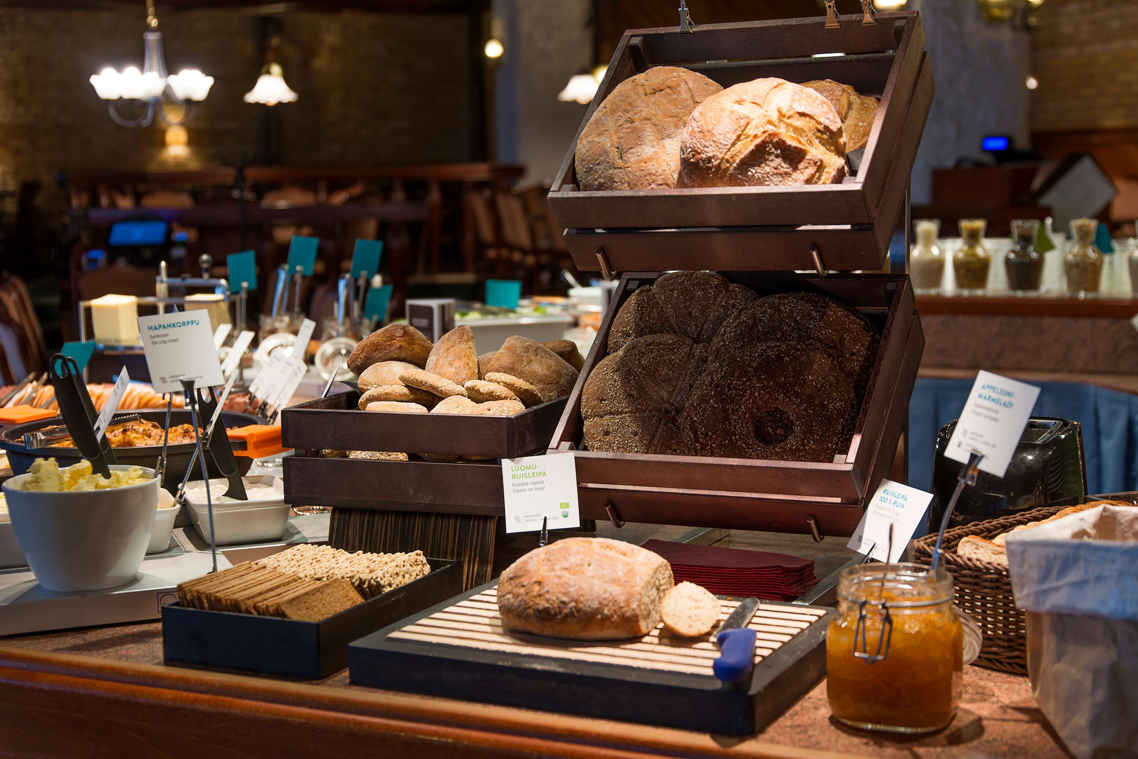 A bakery display with various breads and pastries.