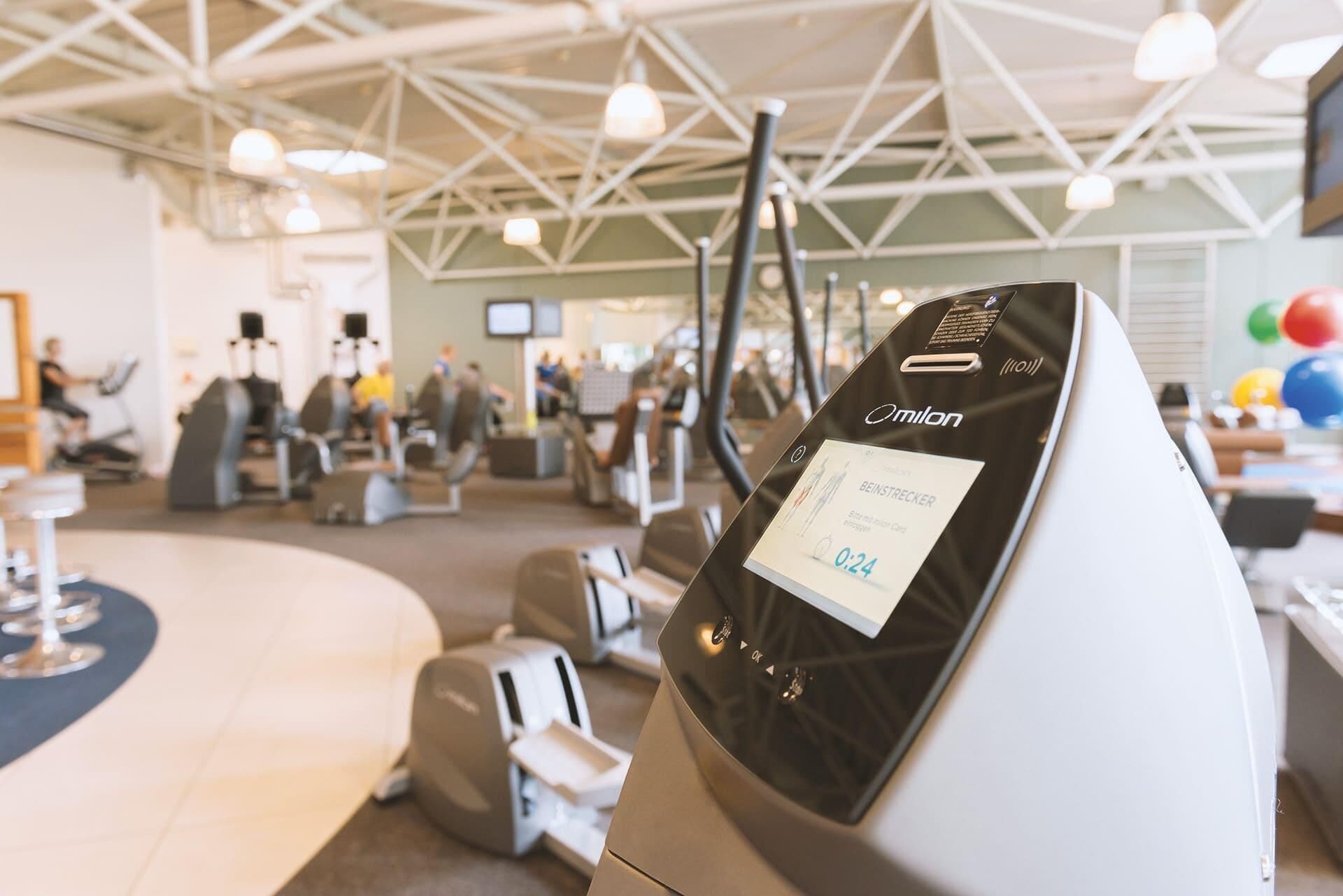 A gym with exercise equipment and a digital display showing a timer.