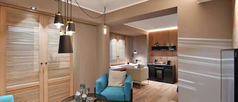 A modern living room with a sofa, a coffee table, and a kitchen area in the background.