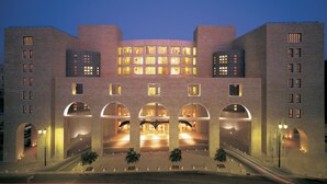A multi-story building with a symmetrical facade, featuring a central courtyard with arches and a series of balconies. - The David Citadel Jerusalem (Jerusalem)
