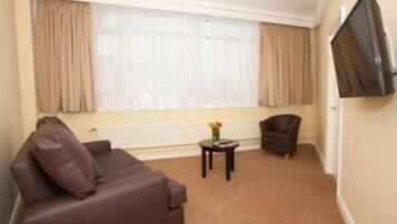 Triple Room, Multiple Beds | Living area | LCD TV