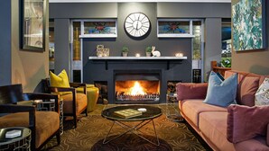 A modern living room with a fireplace, comfortable seating, and decorative elements. - Best Western Sanctuary Inn (Tamworth)