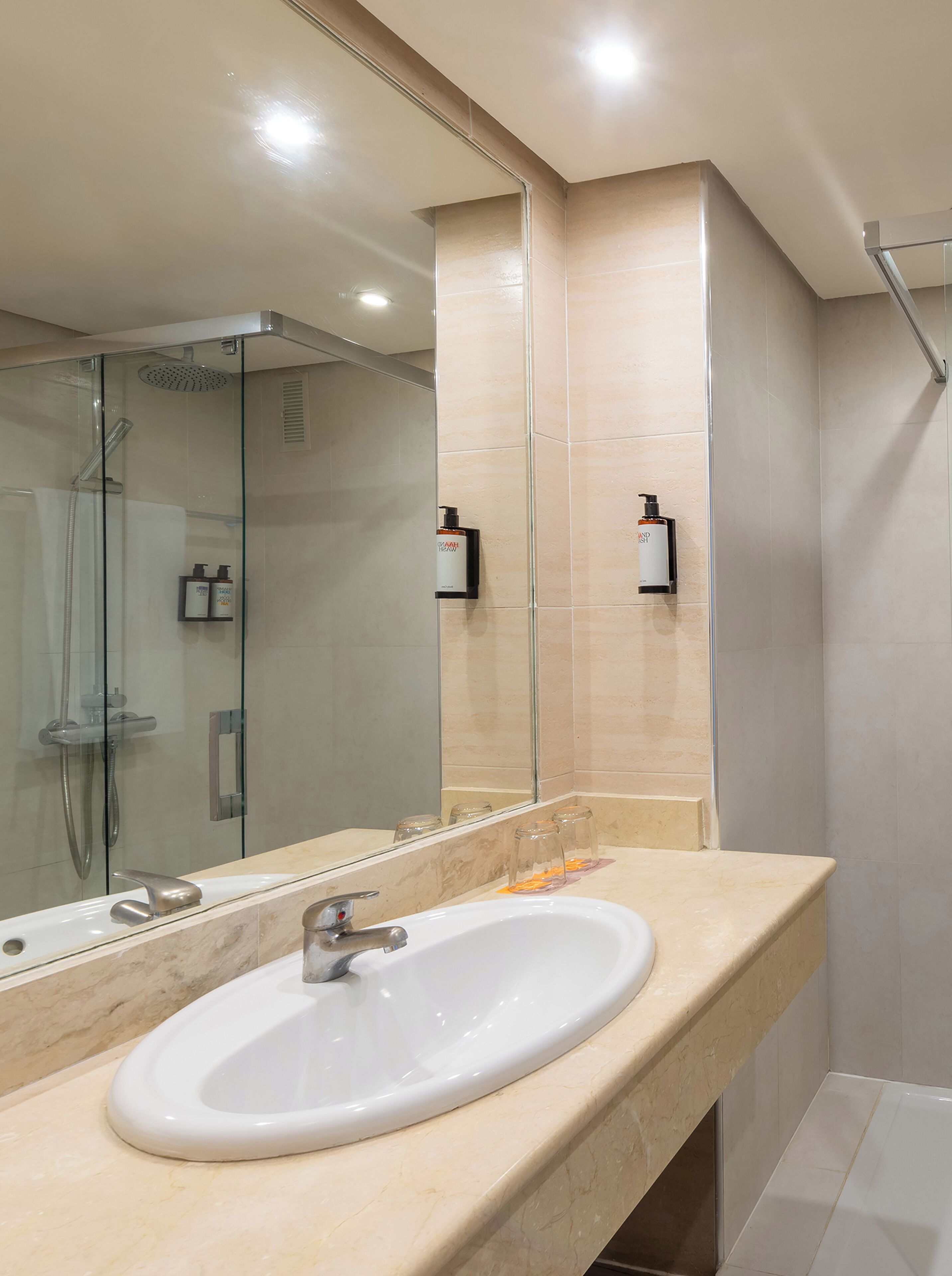 rainfall showerhead, eco-friendly toiletries, hair dryer, towels