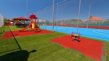 Enjoy a safe and fun outdoor play area with a basketball court and play structures for kids.
